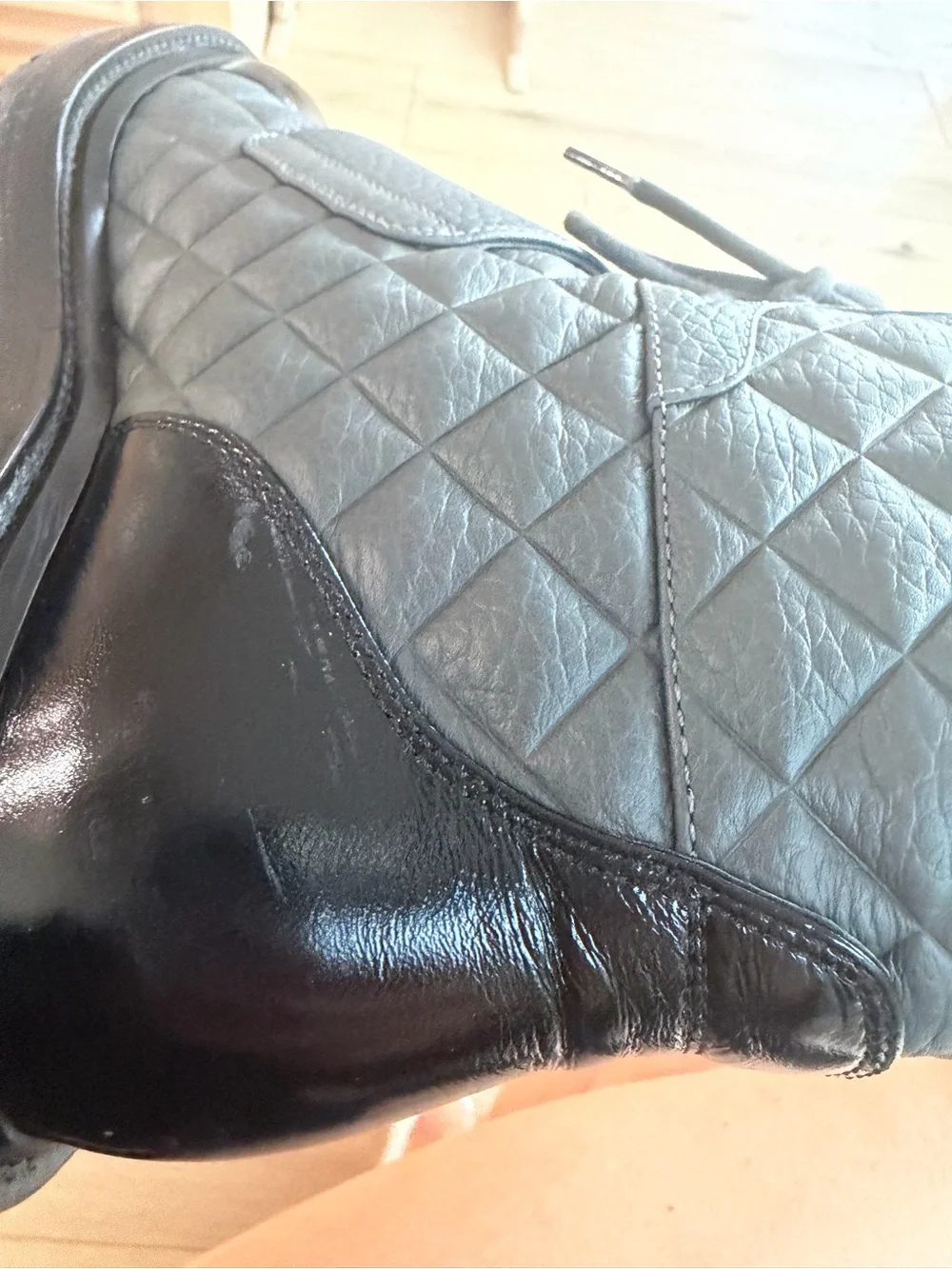 CHANEL Black Quilted Leather Combat Boots with Patent Toe